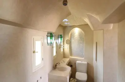 a bathroom with a sink and a toilet and a window at Riad La Tulipe, private, 4 Ch, medina in Marrakech