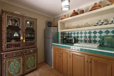 a kitchen with a refrigerator and a sink at Dar Jena, Rare Riad in Medina on Mamounia in Marrakech