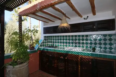 a kitchen with a green and white tiled counter at Dar Jena, Rare Riad in Medina on Mamounia in Marrakech