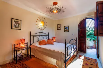 a bedroom with a bed and a mirror on the ceiling at Dar Jena, Rare Riad in Medina on Mamounia in Marrakech
