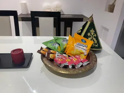 a bowl of candy on a table with a candle at 3 bedroom villa with private pool near centre in Marrakech