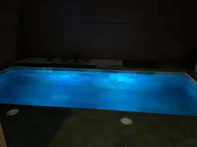a blue swimming pool in a dark room at 3 bedroom villa with private pool near centre in Marrakech