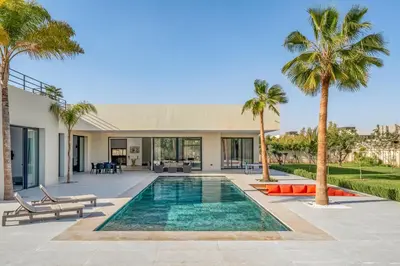 a villa with a swimming pool and palm trees at Villa Alia - Piscine Chauffée - 4 BR BA - Wifi - Parking in Marrakech
