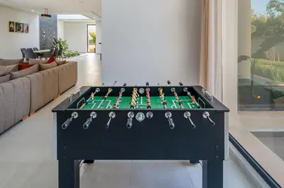 a foosball table in the middle of a living room at Villa Alia - Piscine Chauffée - 4 BR BA - Wifi - Parking in Marrakech