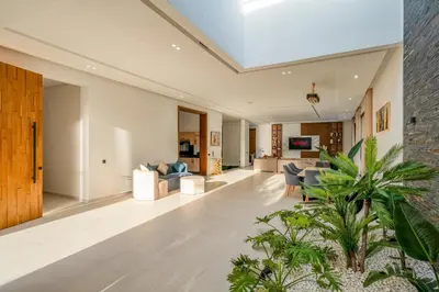 a living room with white furniture and plants at Villa Alia - Piscine Chauffée - 4 BR BA - Wifi - Parking in Marrakech