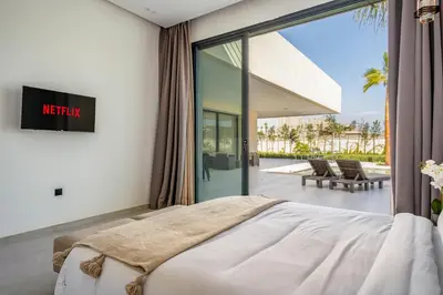 a bedroom with a bed and a view of a patio at Villa Alia - Piscine Chauffée - 4 BR BA - Wifi - Parking in Marrakech