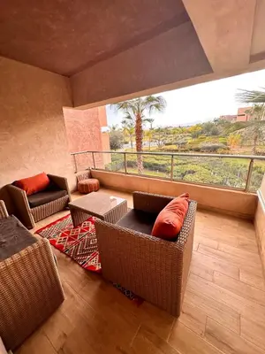 a living room with couches and a large window at Appartement familiale 2 chambres Prestigia in Marrakech
