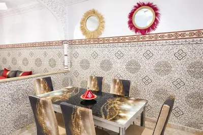 a dining room with a table and chairs at 2 bedroom apartment in heart of Madina in Marrakech