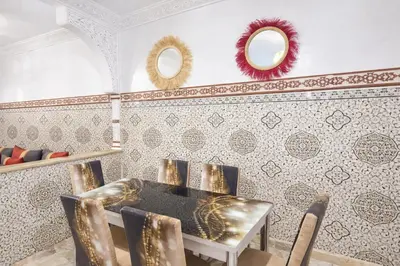 a dining room with a table and two mirrors at 2 bedroom apartment in heart of Madina in Marrakech