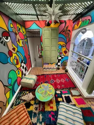 a room with a colorful mural on the wall at Riad dar lfen in Marrakech