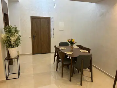 a dining room with a table and chairs and a door at malak g7 in Marrakech