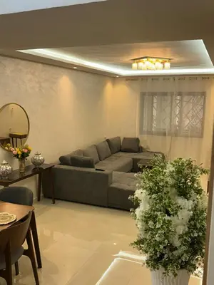 a living room with a couch and a table at malak g7 in Marrakech