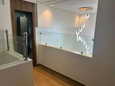 a glass wall with a chandelier in a room at malak g7 in Marrakech