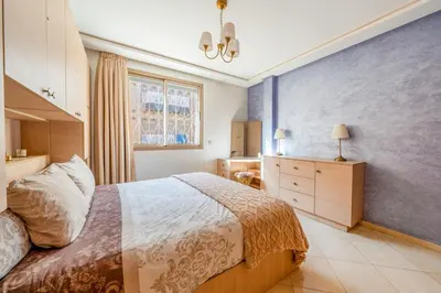 a bedroom with a bed and a dresser and a window at Logement entier Appartement Cosy - Marrakech in Marrakech