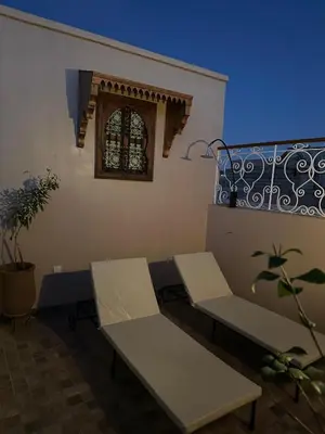 a room with two benches and a window at Dar Manzakin in Marrakech