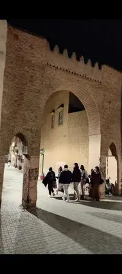 a group of people standing under an archway at Dar Manzakin in Marrakech
