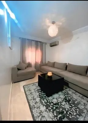 a living room with a couch and a table at سكن امن وهادى in Marrakech