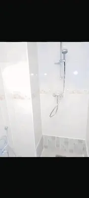 a white bathroom with a shower and a toilet at سكن امن وهادى in Marrakech