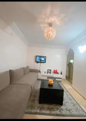 a living room with a couch and a table at سكن امن وهادى in Marrakech