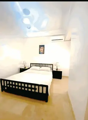 a white bedroom with a bed and a ceiling at سكن امن وهادى in Marrakech