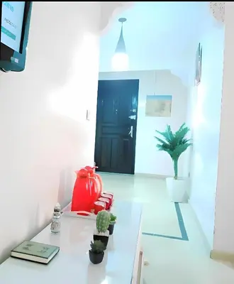 a room with a table with plants and a black door at سكن امن وهادى in Marrakech