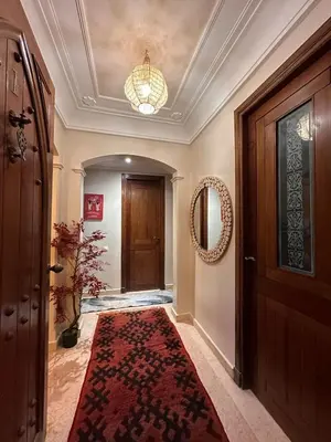 a hallway with a door and a rug on the floor at Marrakech Oasis, Residence Ennaim in Marrakech