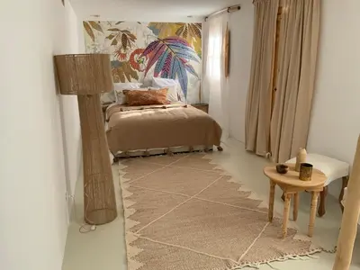 a bedroom with a bed and a lamp and a table at Riad 24 in Marrakech