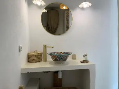 a bathroom with a sink and a mirror on the wall at Riad 24 in Marrakech