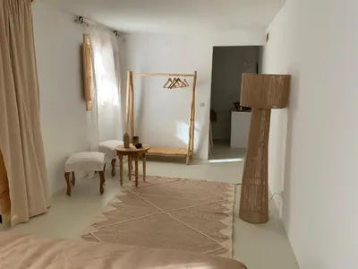 a bedroom with a mirror and a chair and a lamp at Riad 24 in Marrakech