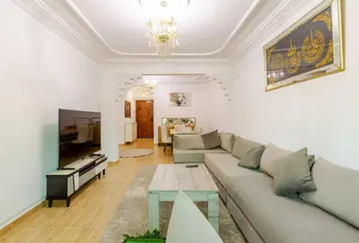 a living room with a couch and a table at Charming Two-Bedroom Apartment in Gueliz,Marrakesh in Marrakech
