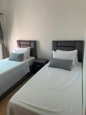 two beds sitting next to each other in a room at Charming Two-Bedroom Apartment in Gueliz,Marrakesh in Marrakech