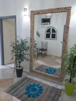 a mirror in a room with a table and a chair at Cute affordable apartment in Marrakech