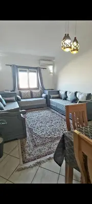 a living room with a couch and a table at Cute affordable apartment in Marrakech