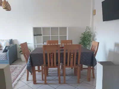 a dining room table with chairs and a table cloth at Cute affordable apartment in Marrakech