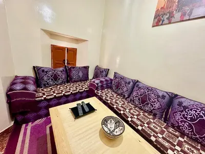 a living room with a purple couch and a table at Dar Safary in Marrakech