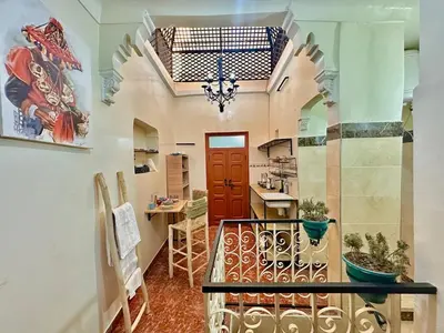 a hallway with a red door and a chandelier at Dar Safary in Marrakech