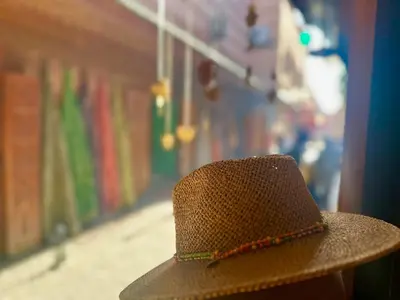 a person wearing a straw hat on a street at Dar Safary in Marrakech