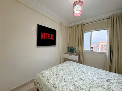 a bedroom with a bed and a sign on the wall at 1BR Chic à Izdihar Clim, Wi-Fi & Cuisine Équipée in Marrakech