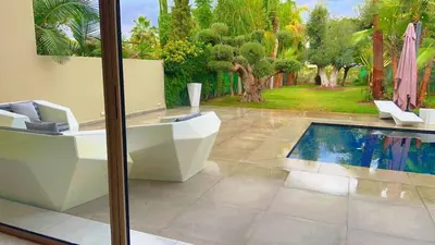 a bathroom with a toilet and a swimming pool at villa du golf in Marrakech