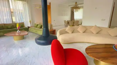 a living room with a couch and a table at villa du golf in Marrakech