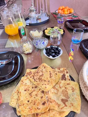 a wooden table with plates of food on it at Charming townhouse in Marrakech in Marrakech