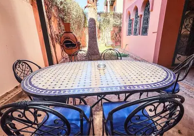 a blue table and chairs on a patio at Charming townhouse in Marrakech in Marrakech