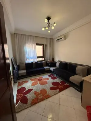 a living room with a couch and a rug at Magnifique appartement in Marrakech