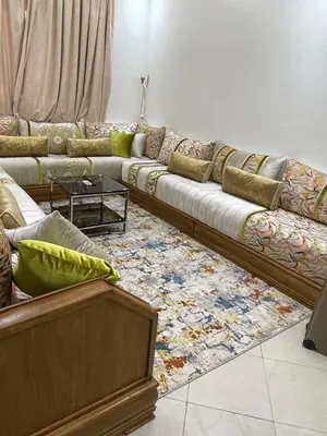 a living room with a long couch and a rug at Apartment in Marrakesh in Marrakech