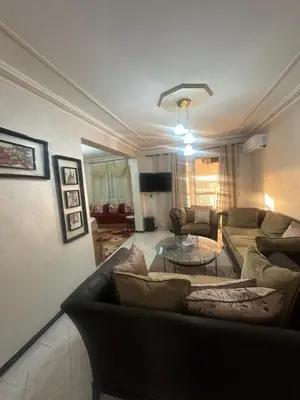 a living room with a couch and a table at Appartement Layane 2 chambres 8 mn de gueliz in Marrakech