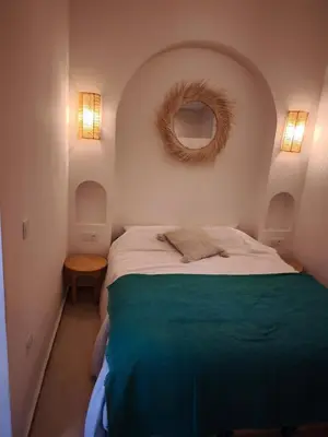 a bedroom with a large bed with a round mirror at Riad Choubi 3 Bedroom Medina in Marrakech