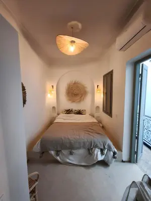 a bedroom with a large bed in a room at Riad Choubi 3 Bedroom Medina in Marrakech