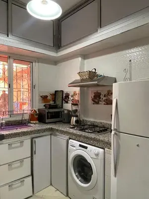 a kitchen with a washing machine and a refrigerator at شقة سكنية للايجار بمراكش in Marrakech
