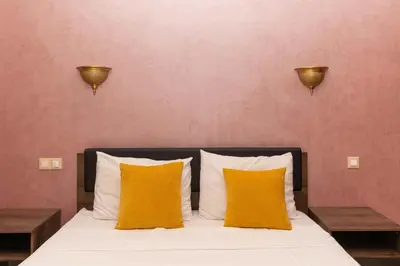 a bedroom with a bed with two yellow pillows at Marrakech Private Pool Villa in Marrakech