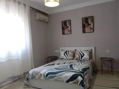 a bedroom with a bed and a window at Cosy and spacious apartment in Gueliz in Marrakech